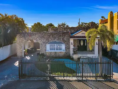 a house with a fence in front of it at Coral Suite close to Little Havana in Miami