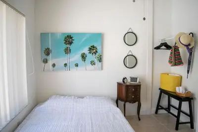 a bedroom with a bed and a picture of palm trees at Stay Near Miami's Cultural Heart With Wifi in Miami