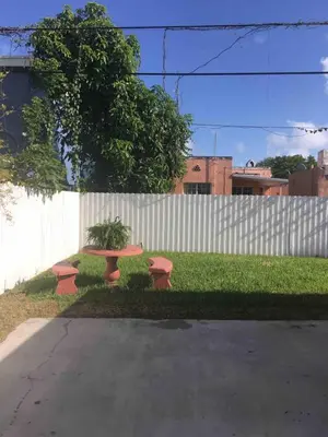 a picnic table and two benches in front of a fence at Stay Near Miami's Cultural Heart With Wifi in Miami