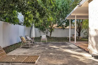 a patio with chairs and an umbrella in a backyard at Private room in Little Havana in Miami