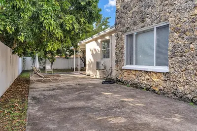 a house with a bench next to a building at Private room in Little Havana in Miami
