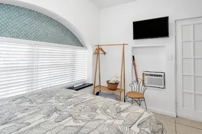 a bedroom with a bed and a flat screen tv at Private Studio in Little Havana in Miami