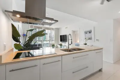 a kitchen with white cabinets and a sink at ** W ICON BRICKELL-LUXURY UNIT- FREE SPA** in Miami