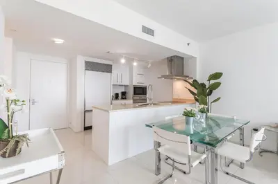 a kitchen and dining room with a glass table at ** W ICON BRICKELL-LUXURY UNIT- FREE SPA** in Miami