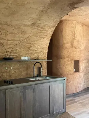 a kitchen with a sink and a stone wall at Casa Kawa lumicollection in Miami