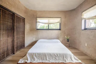 a bedroom with a large bed and two windows at Casa Kawa lumicollection in Miami