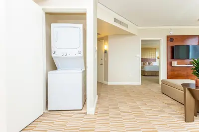 a kitchen and living room with a washer and dryer at Trump International Beach Resort Ocean View 1100 sf 1 Bed 1Bth Privately Owned Sunny Isles in Miami Beach