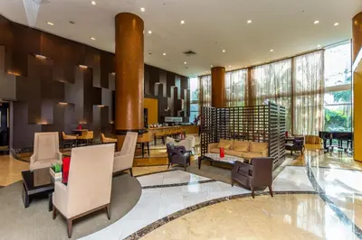 a lobby of a hotel with chairs and tables at Trump International Beach Resort Ocean View 1100 sf 1 Bed 1Bth Privately Owned Sunny Isles in Miami Beach