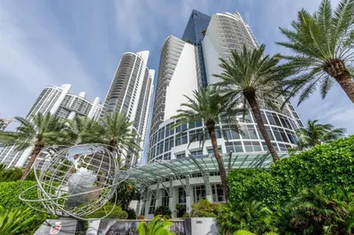 a building with palm trees in front of tall buildings at Trump International Beach Resort Ocean View 1100 sf 1 Bed 1Bth Privately Owned Sunny Isles in Miami Beach