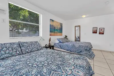 a bedroom with two beds and a window at Boho Studio in Little Havana in Miami