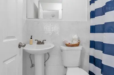 a white bathroom with a sink and a toilet at Boho Studio in Little Havana in Miami