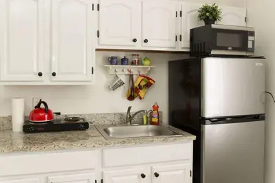 a kitchen with a sink and a refrigerator at 1 Bedroom Apt near Coconut Grove in Miami