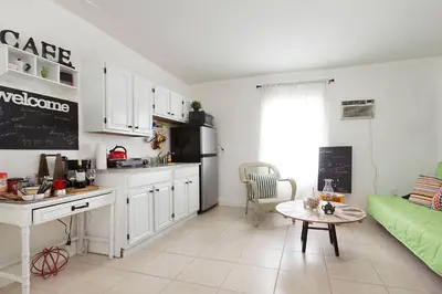 a kitchen and living room with a couch and a table at 1 Bedroom Apt near Coconut Grove in Miami