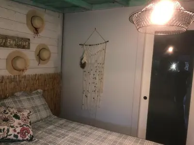 a bedroom with a bed with a curtain hanging on the wall at Independent Studio in Little Havana in Miami