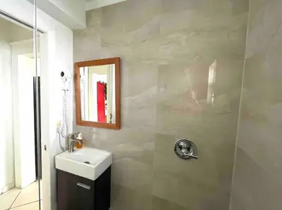 a bathroom with a sink and a mirror at Private Room in the Heart of Calle Ocho in Miami