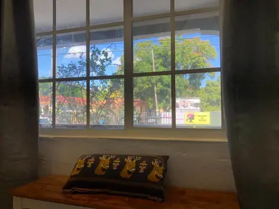 a pillow sitting on a table in front of a window at Private Room in the Heart of Calle Ocho in Miami