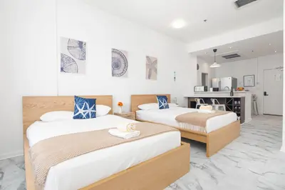 a hotel room with two beds and a kitchen at Girasole Suites in Miami Beach