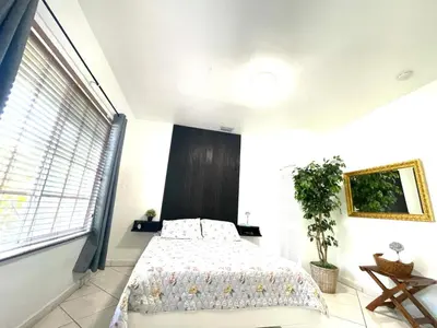 a bedroom with a bed and a large window at Private Suite next to Calle Ocho in Miami