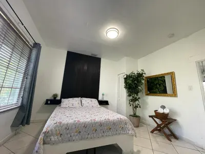 a bedroom with a bed and a large window at Private Suite next to Calle Ocho in Miami