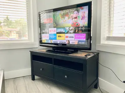 a flat screen tv sitting on top of a dresser at Adorable private apartments in the Heart of Miami! in Miami