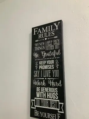 a chalkboard with a family rules sign on a wall at Adorable private apartments in the Heart of Miami! in Miami