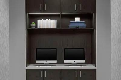 a book shelf with two computer monitors on it at AC Hotel by Marriott Miami Dadeland in Miami