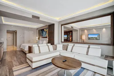 a living room with a couch and a bed at Coastal studio w hot tub gym access in Fort Lauderdale