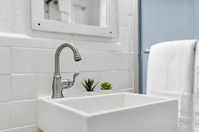 a white sink in a bathroom with a mirror at Alani Bay Villas in Fort Lauderdale