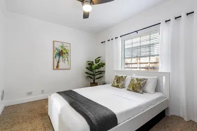 a white bedroom with a bed and a window at Alani Bay Villas in Fort Lauderdale