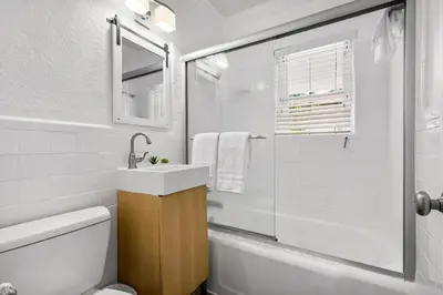 a white bathroom with a sink and a shower at Alani Bay Villas in Fort Lauderdale