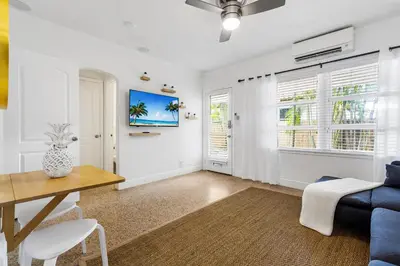 a living room with a table and a blue couch at Alani Bay Villas in Fort Lauderdale