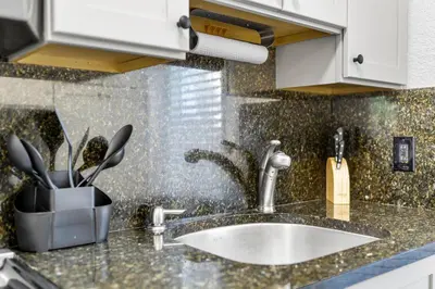 a kitchen counter with a sink and a knife holder at Alani Bay Villas in Fort Lauderdale