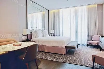 a hotel room with a bed and a table and chairs at Aluna Lux Suites at SLS Lux Brickell Building in Miami