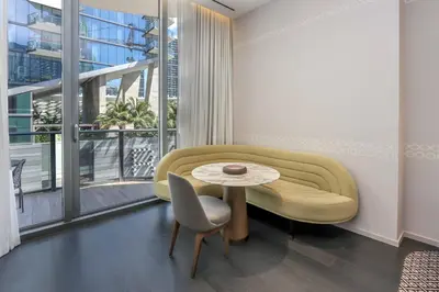 a living room with a couch and a table at Aluna Lux Suites at SLS Lux Brickell Building in Miami