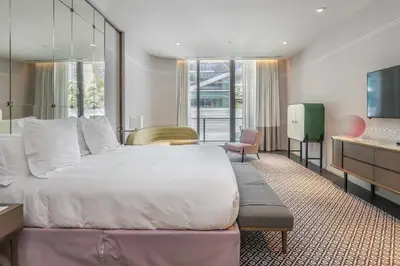 a hotel room with a large bed and a desk at Aluna Lux Suites at SLS Lux Brickell Building in Miami