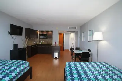 a hotel room with a bed and a kitchen at Penthouse in the sky in Miami Beach