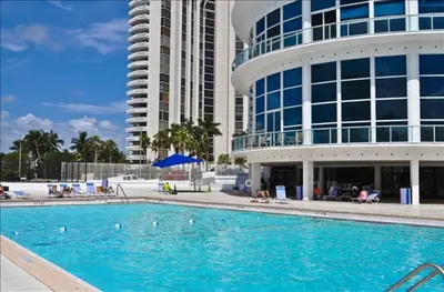 a large swimming pool in front of a building at Penthouse in the sky in Miami Beach