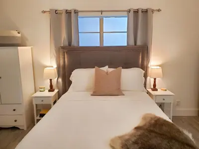 a bedroom with a large white bed with a window at Stylish & Newly-Renovated Suites near Las Olas in Fort Lauderdale