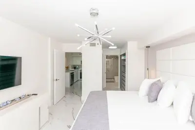 a white bedroom with a bed and a ceiling fan at Yacht Club at Aventura Lux 2 Bed 2 Bath Brand New 2021 in Aventura
