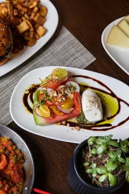 two plates of food on a table with food at AC Hotel by Marriott Fort Lauderdale Airport in Dania Beach