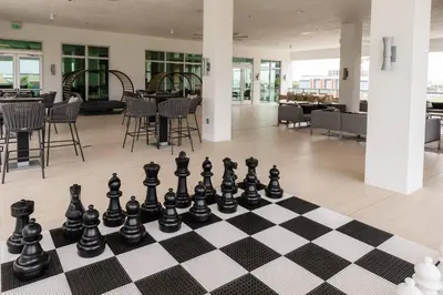 a chess board sitting on the floor in a room at AC Hotel by Marriott Fort Lauderdale Airport in Dania Beach