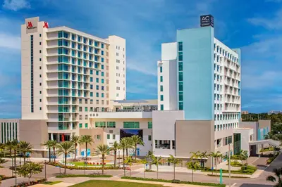 two tall buildings in a city with palm trees at AC Hotel by Marriott Fort Lauderdale Airport in Dania Beach