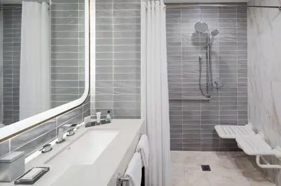 a bathroom with a tub and a sink and a shower at Marriott Fort Lauderdale Airport in Dania Beach