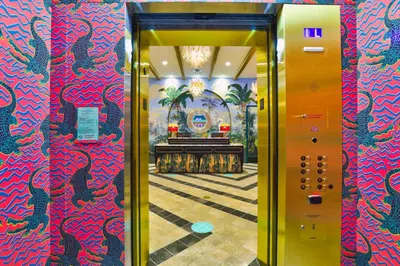 an elevatorexit to a lobby with a red and blue wall at The Goodtime Hotel, Miami Beach a Tribute Portfolio Hotel in Miami Beach