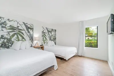 a bedroom with two beds and a window at Doral Inn & Suites Miami Airport West in Miami