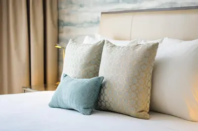 a group of pillows sitting on top of a bed at Iberostar Waves Miami Beach in Miami Beach