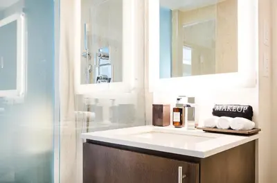 a bathroom with a white sink and a shower at Iberostar Waves Miami Beach in Miami Beach