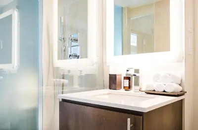 a bathroom with a white sink and a shower at Iberostar Waves Miami Beach in Miami Beach