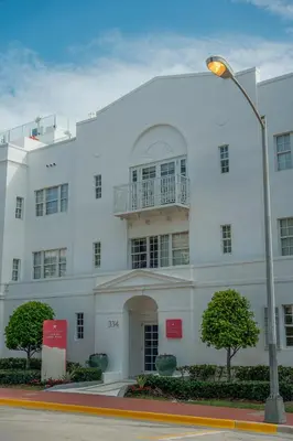 a white building with a balcony on top of it at Iberostar Waves Miami Beach in Miami Beach