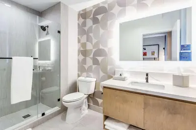 a bathroom with a toilet and a sink and a shower at SERENA Hotel Aventura Miami, Tapestry Collection by Hilton in Aventura